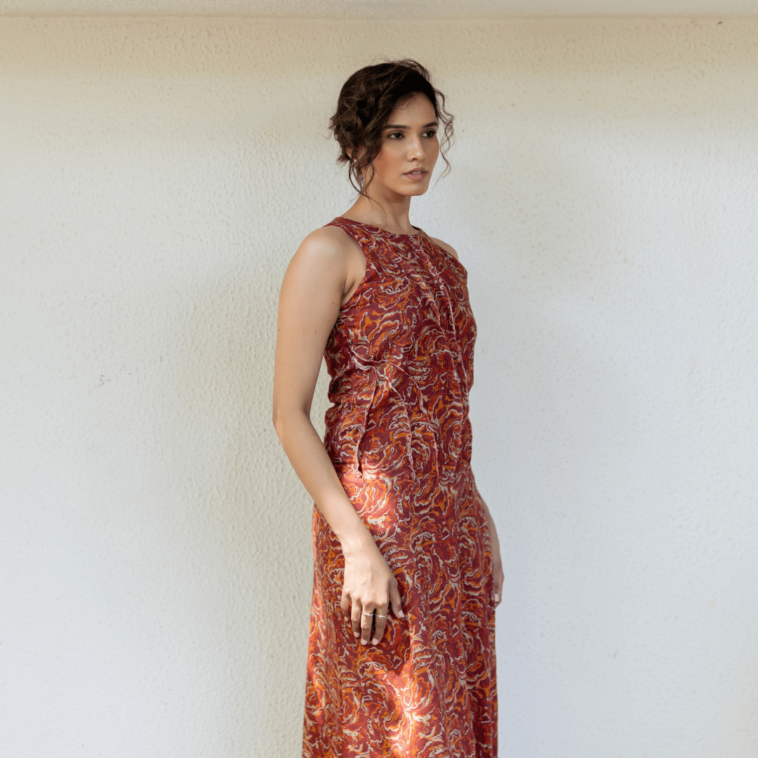 Sleeveless linen maxi dress with rust and orange swirling pattern, round neckline
