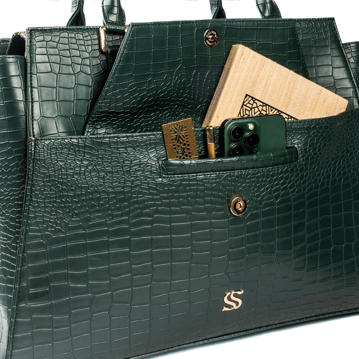 Green croc-textured tote bag open top showing interior pockets and vanity pouch