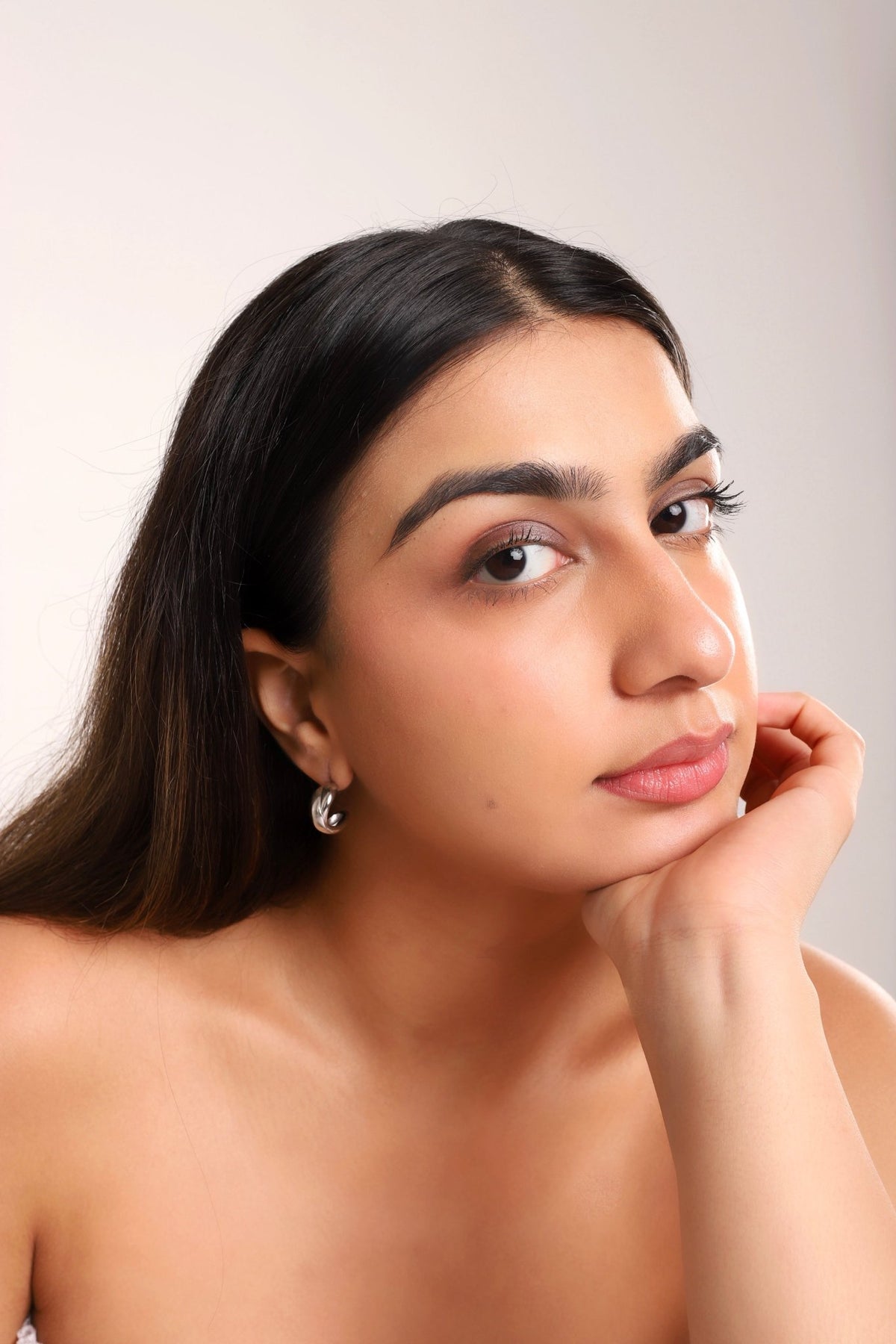 Silver hoop earrings with frosted oval centerpiece