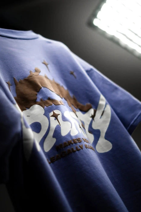 Lavender graphic T-shirt close-up with crown and flame-style design