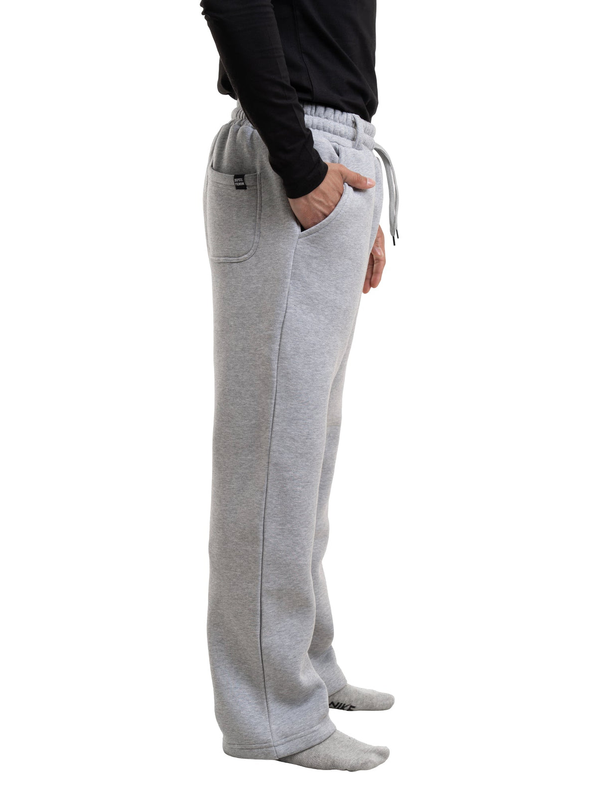Grey fleece sweatpants with drawstring, side pockets, and elastic waist cuff