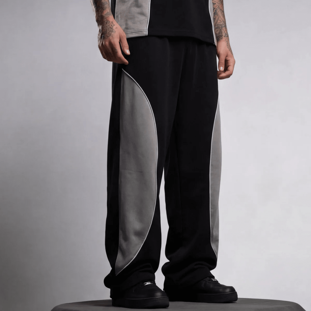 Black baggy sweatpants featuring light gray side panels and wide-leg drape