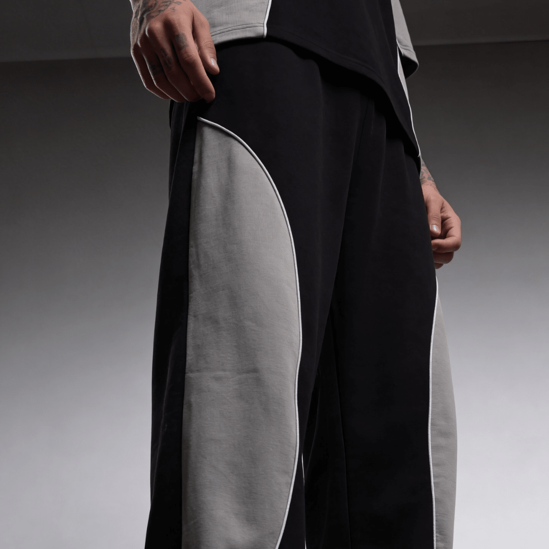 Black baggy sweatpants with light gray side panel detail on the thigh