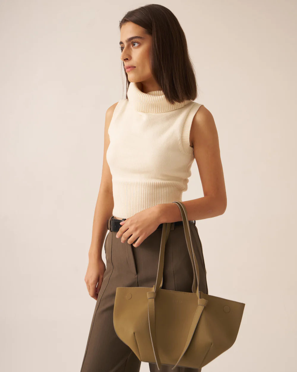 Olive tote bag with zip pouch, worn with side shoulder strap detail