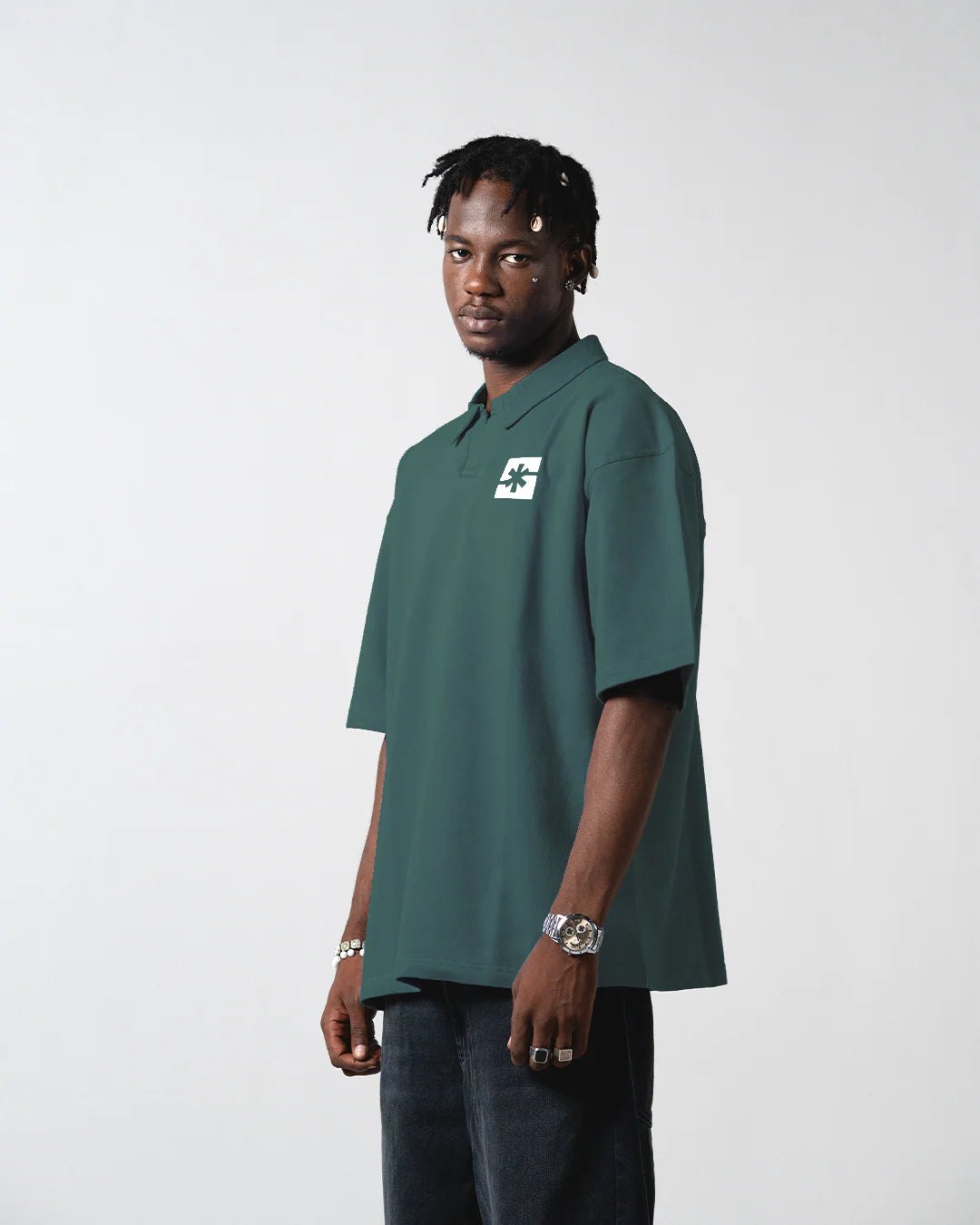 Forest green polo shirt with short sleeves and chest logo patch