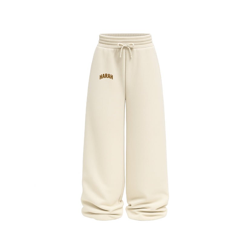 Beige sweatpants with drawstring waistband and "HARAH" logo patch on the left leg.