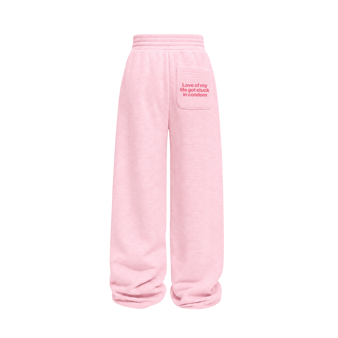 Pink sweatpants with elastic waistband and relaxed wide legs, featuring side patch pocket.