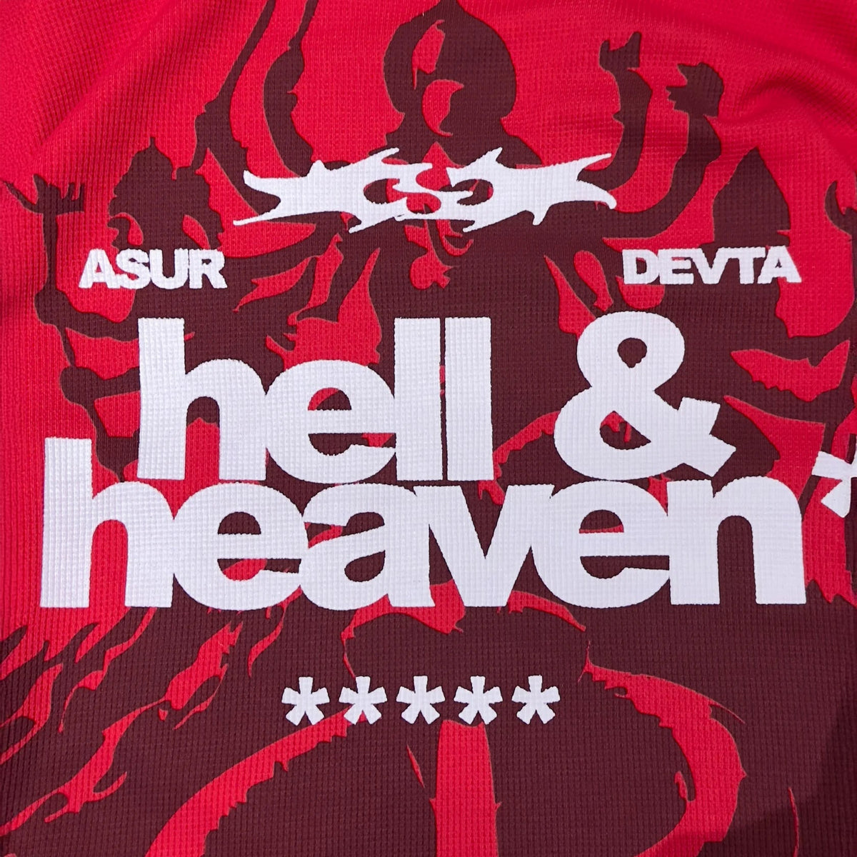 Red long-sleeve waffle knit top close-up with large “hell & heaven” lettering and “ASUR”