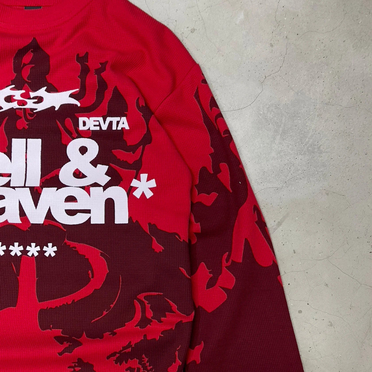 Red long-sleeve waffle knit top side view with “DEVTA” and “hell & heaven” print