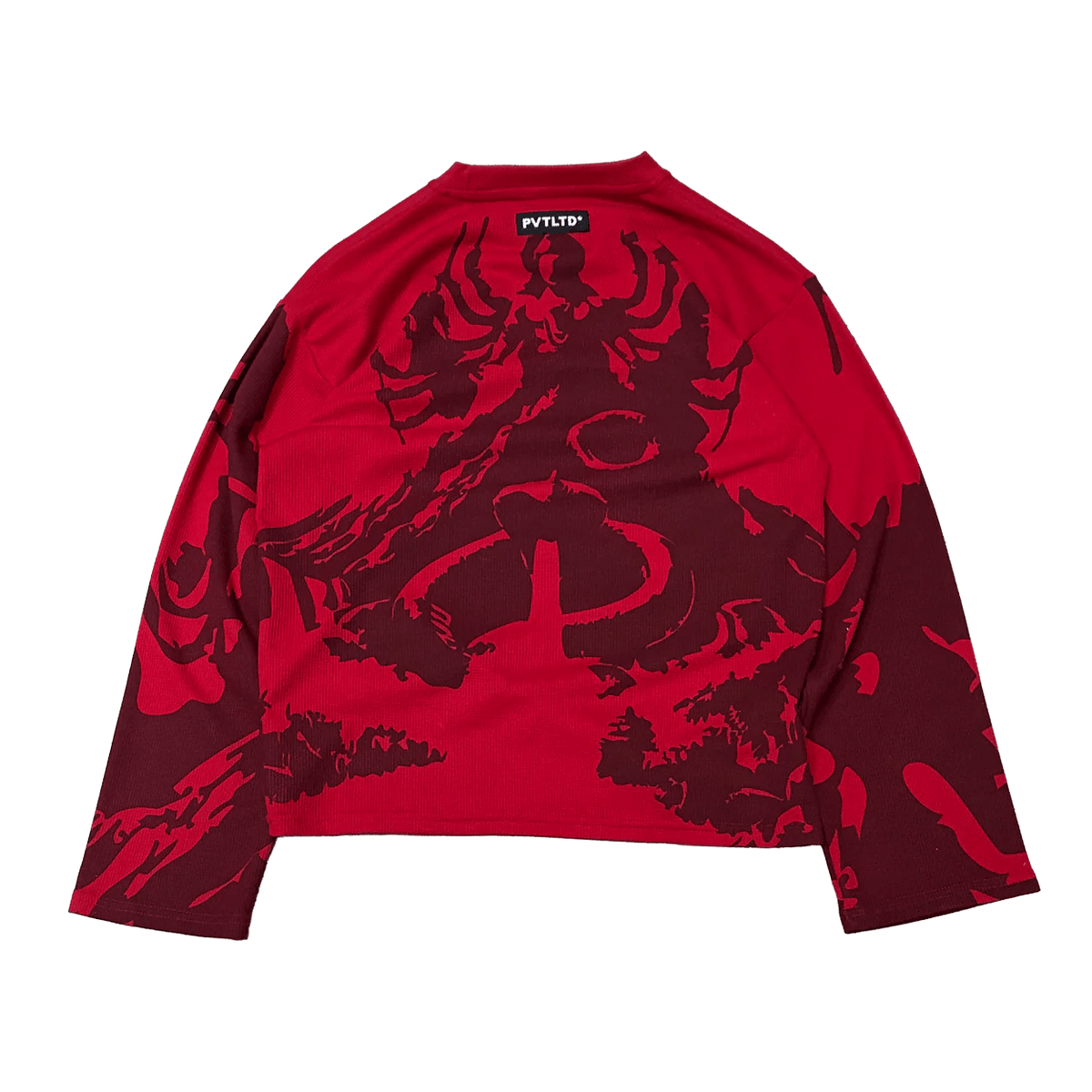 Red long-sleeve cropped waffle knit top with central dark graphic on back
