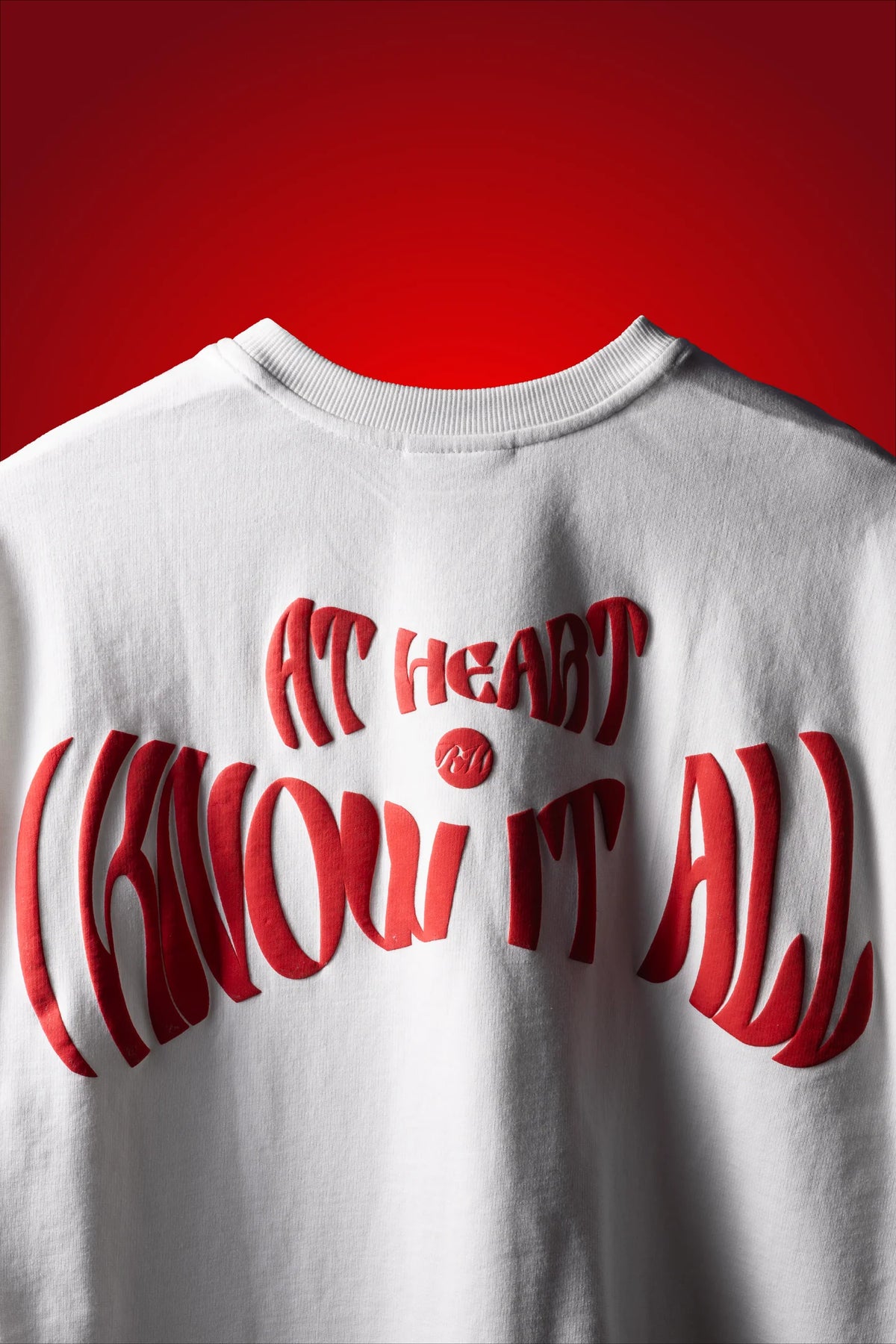 White crew-neck T-shirt with large red back graphic and stylized lettering.