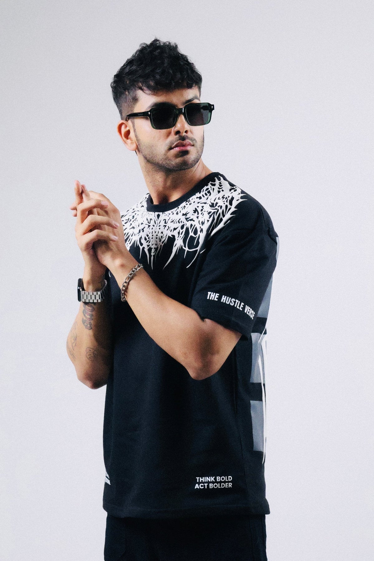 Oversized black T-shirt with white crown drip print and small sleeve logo