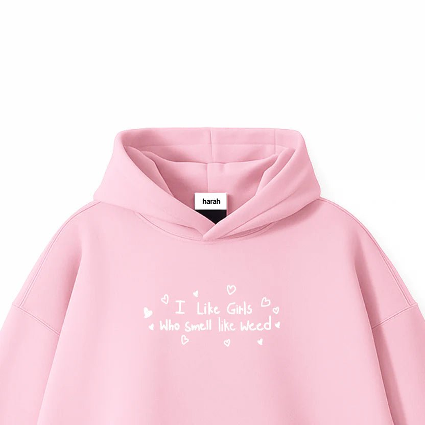 Pink pullover hoodie close-up with hood, small heart text graphic on chest