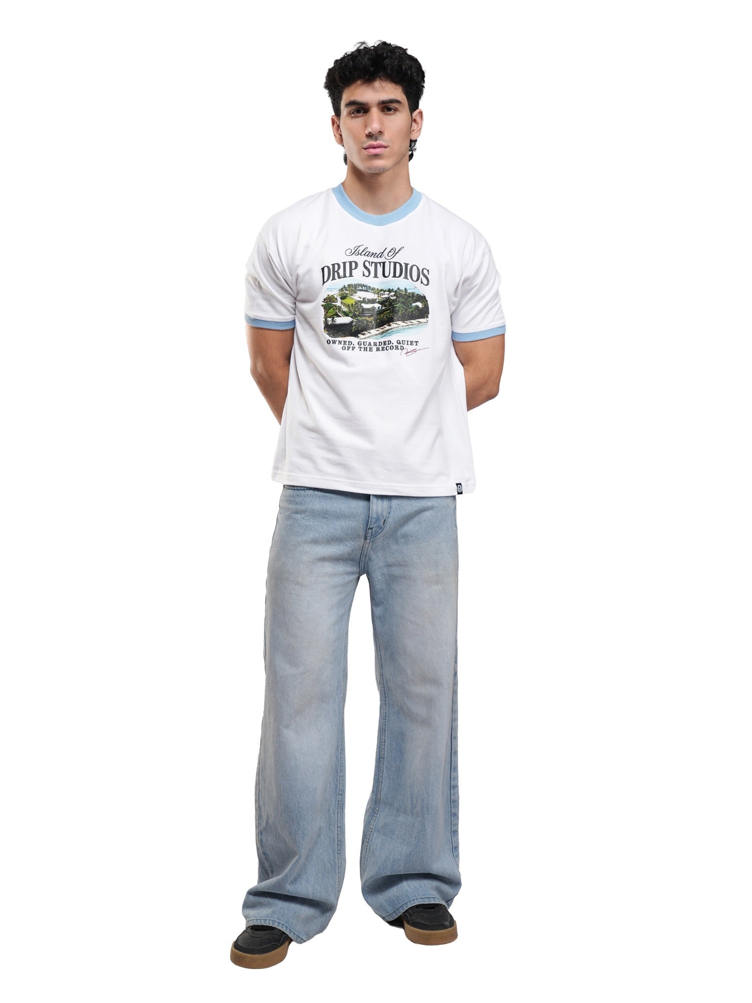 White ringer tee with light blue trim and front graphic; full-body view with jeans