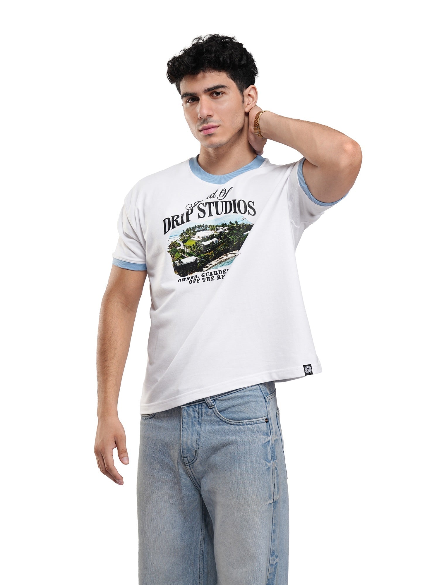 White ringer tee with light blue sleeve trim and front graphic print; man posing with one hand up