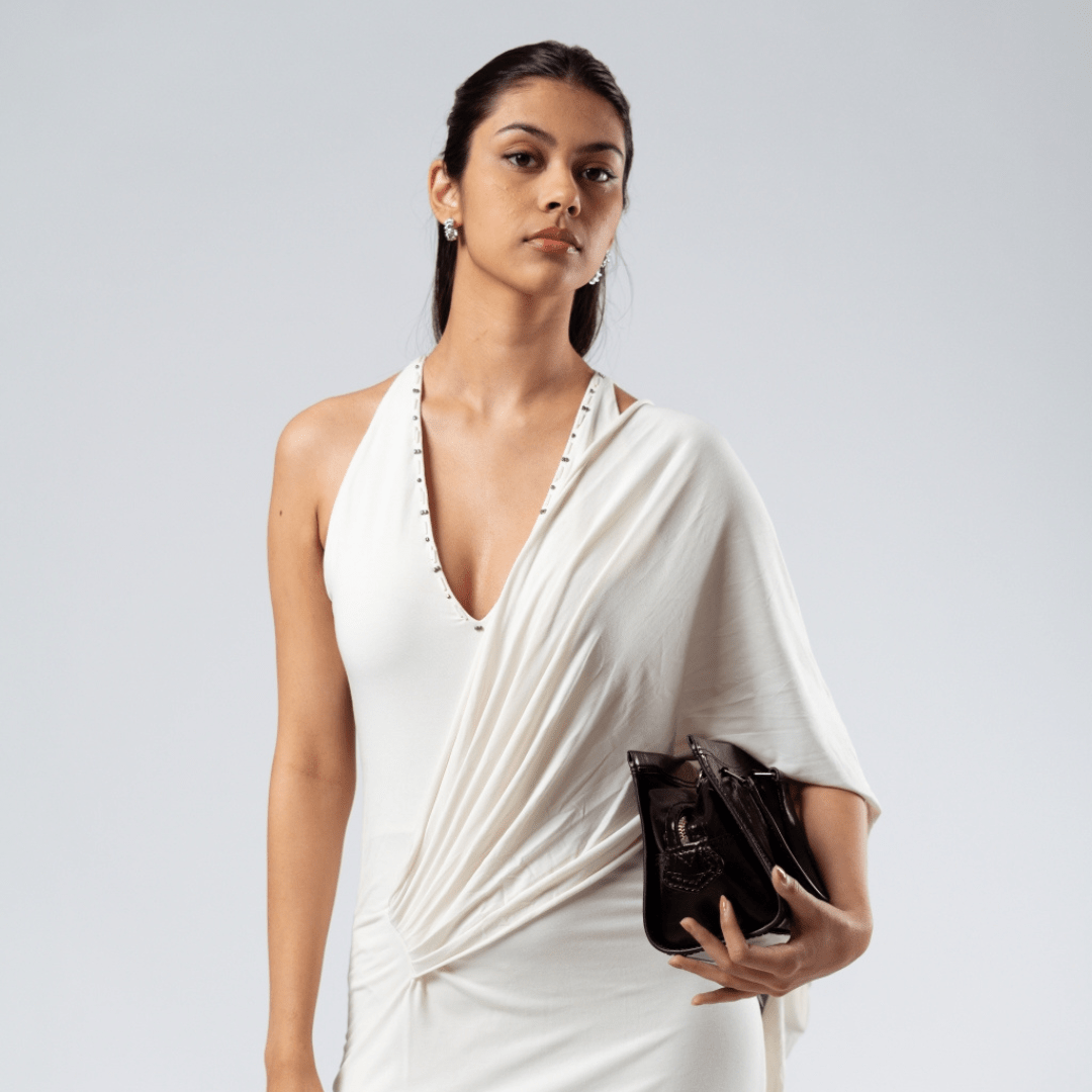 Ivory drape gown with one-shoulder wrap and V-neckline, studded strap trim