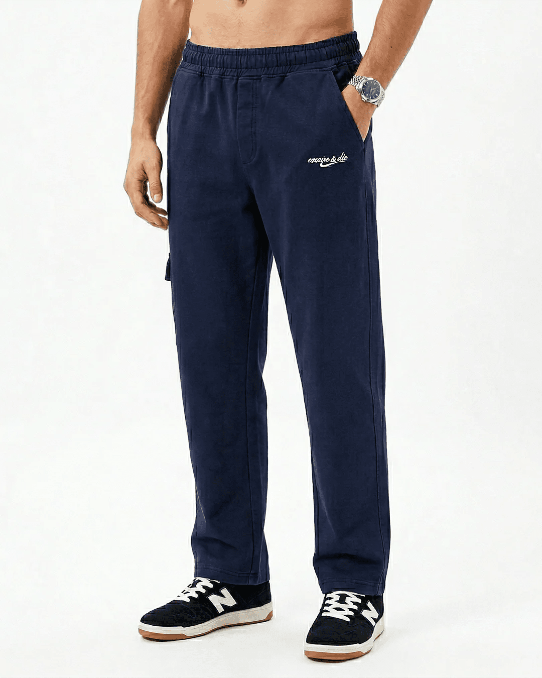 Navy blue sweatpants with elastic waistband, side pockets, and cuffed ankle hem.
