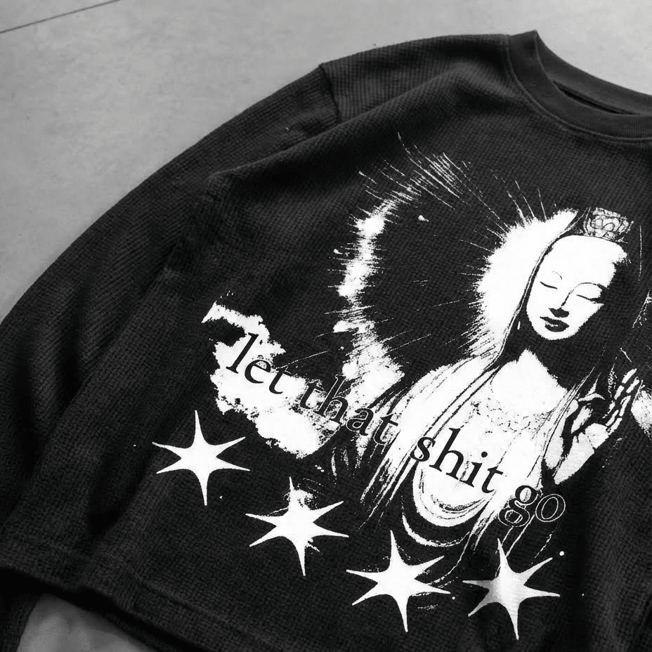 Black waffle knit tee with front graphic of a woman, stars, and slogan print
