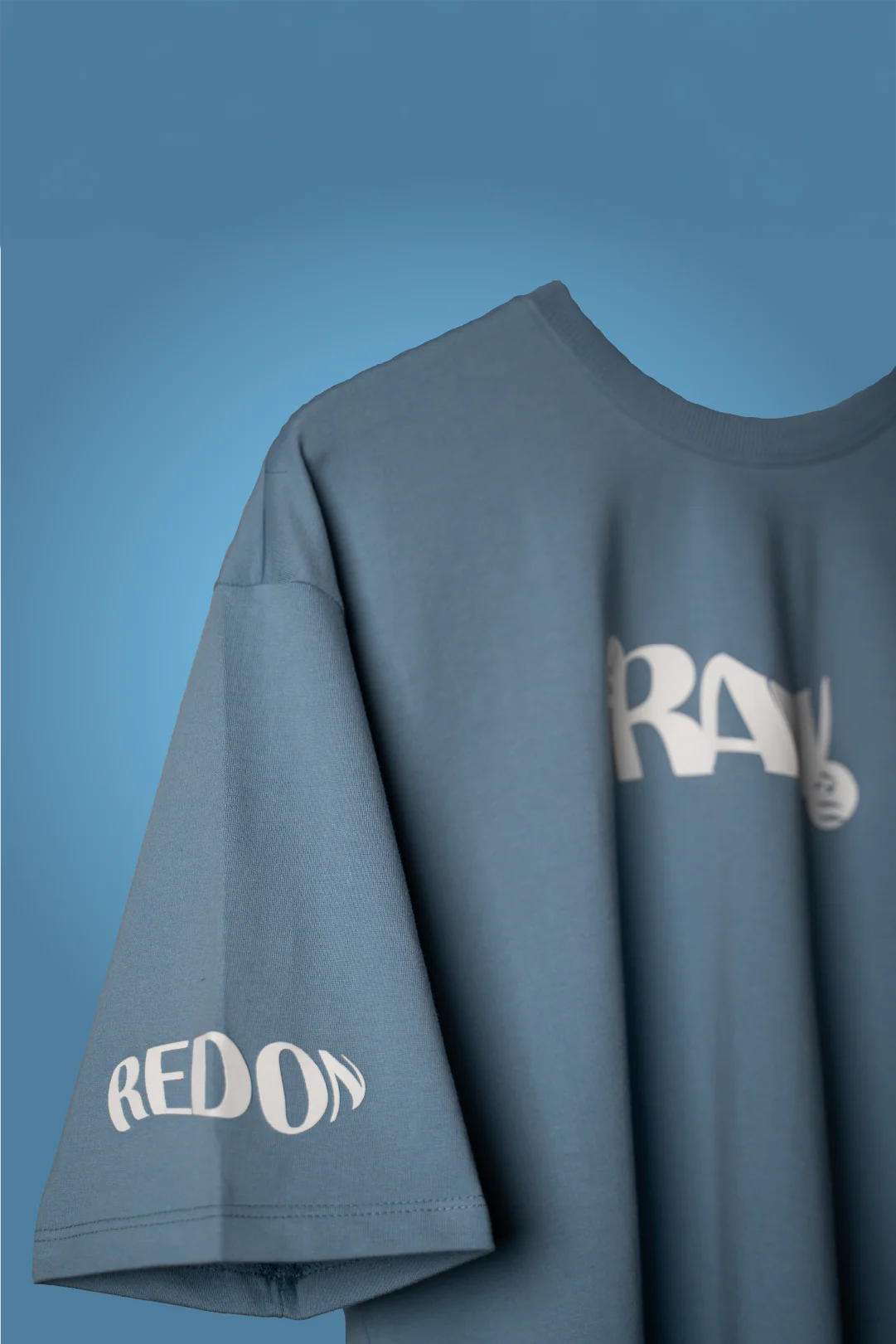 Light blue graphic T-shirt with side “RED ON” print on sleeve hem and RAW logo