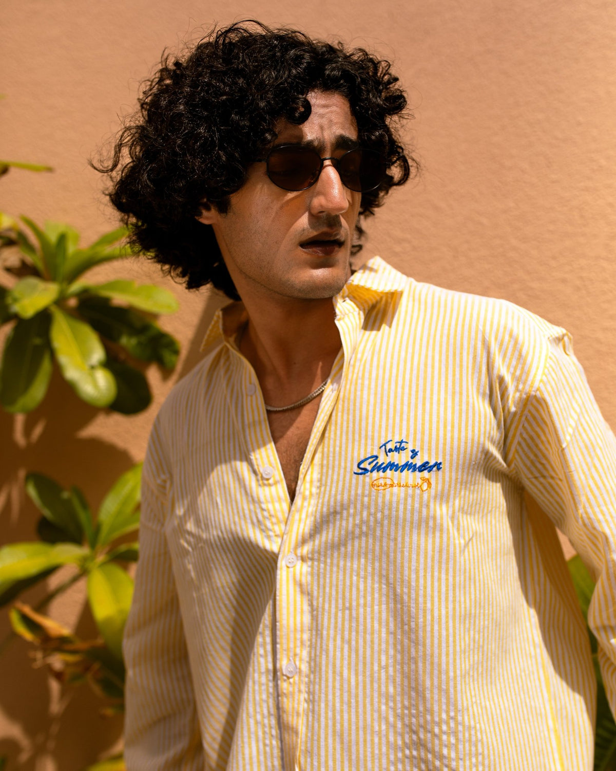 Yellow striped seersucker button-up shirt with chest logo and open neckline