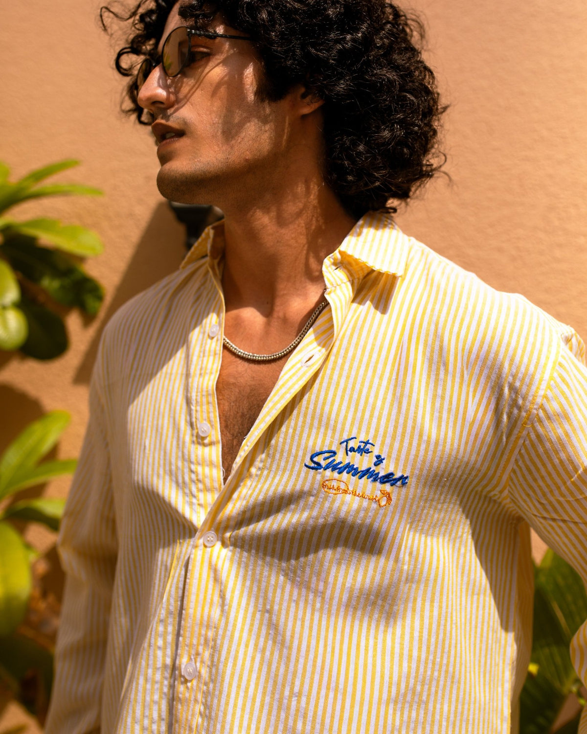 Yellow seersucker striped shirt with pointed collar and embroidered chest logo