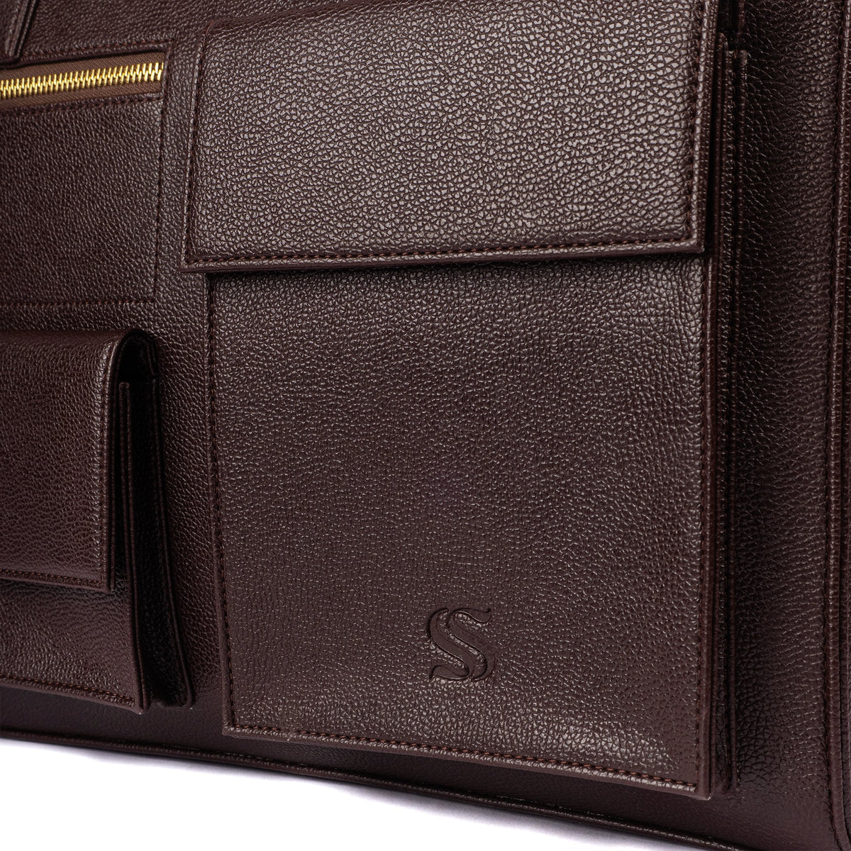 Dark brown leather-look tote front panel with flap pocket and embossed S logo