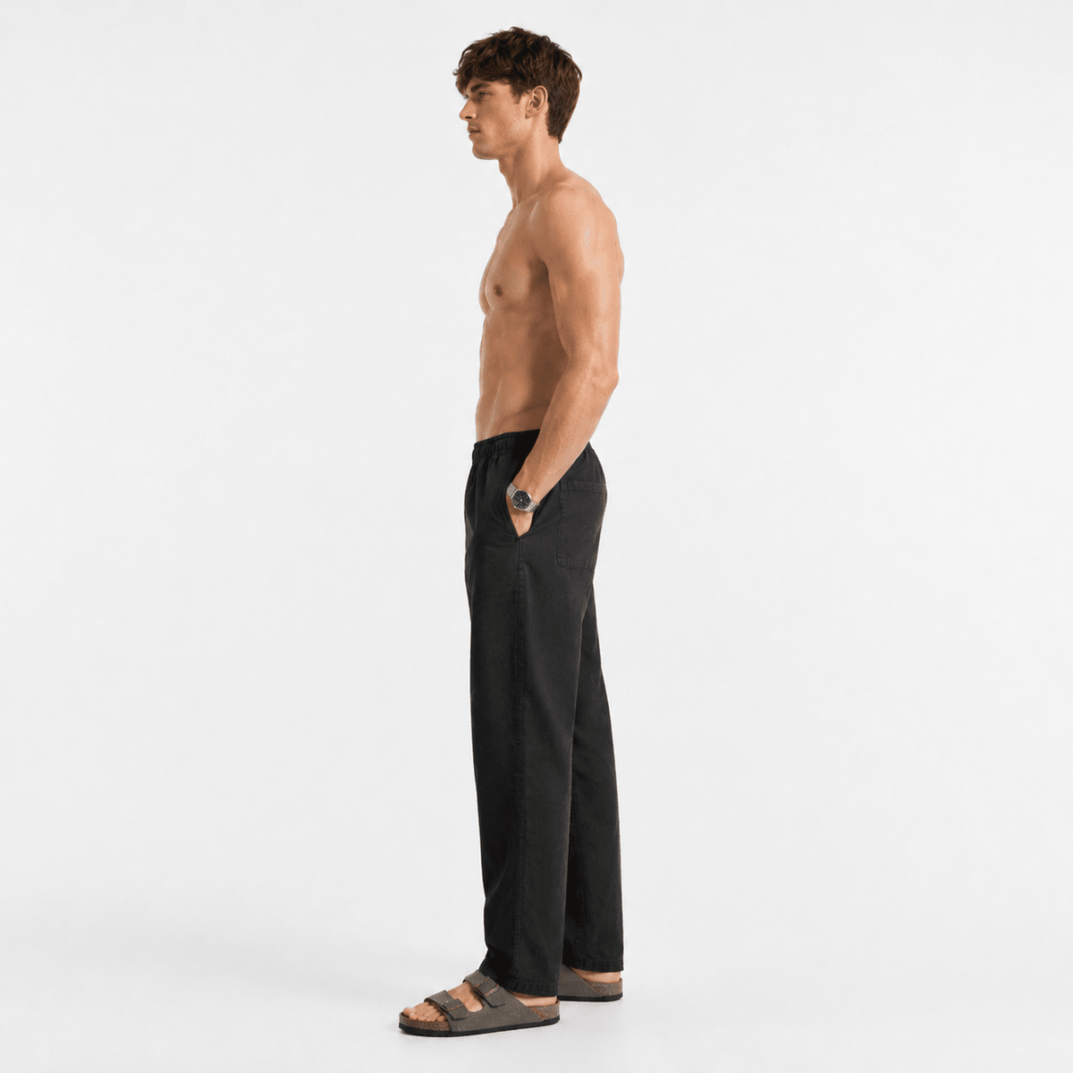 Black linen pull-on pants side view, elastic waistband and straight relaxed legs