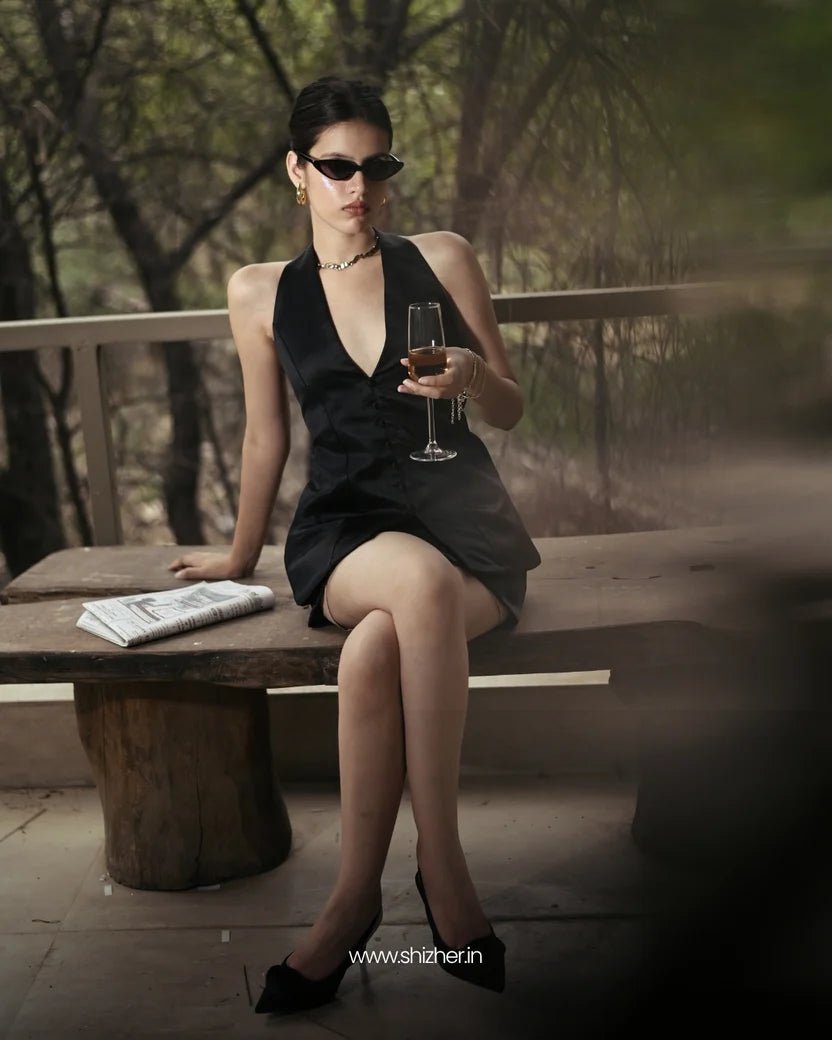 Black halter satin mini dress with deep V neckline and sleeveless halter straps