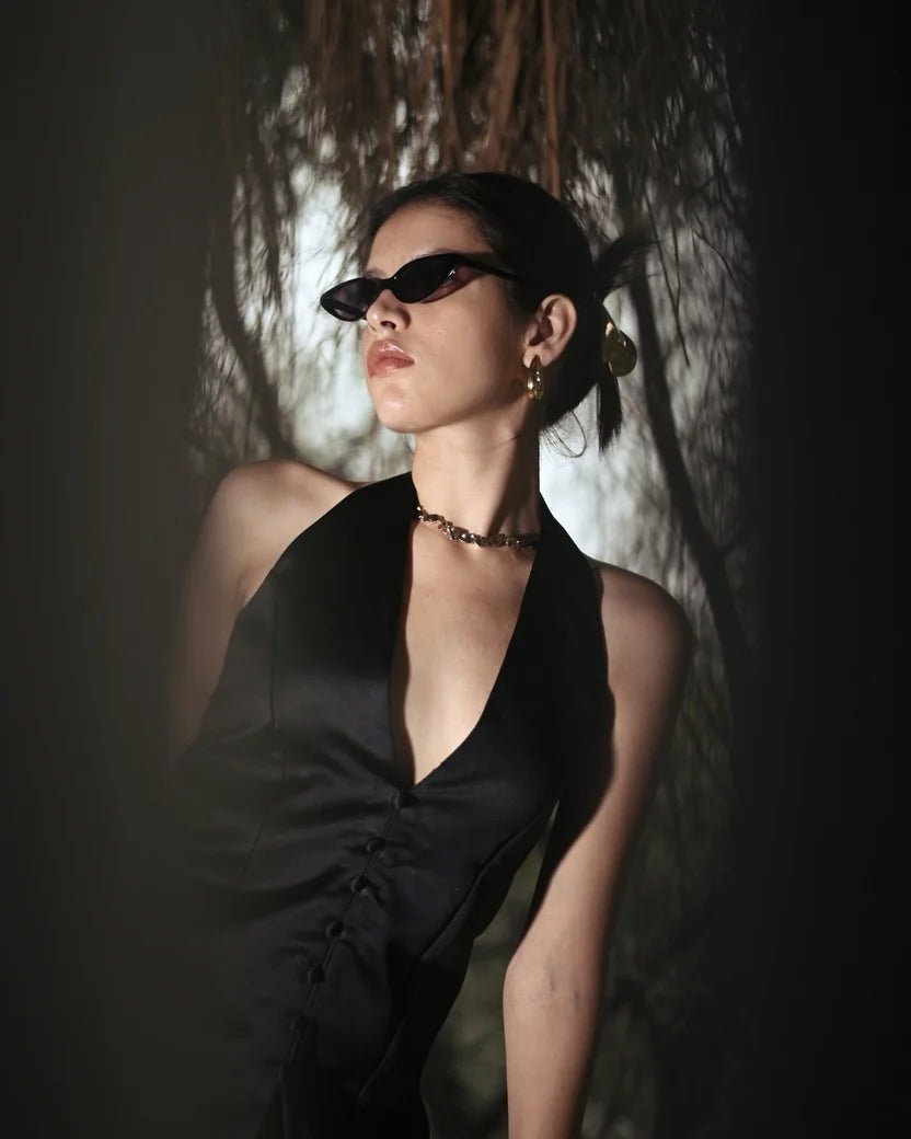 Black halter satin mini dress with deep V neckline and ruched front