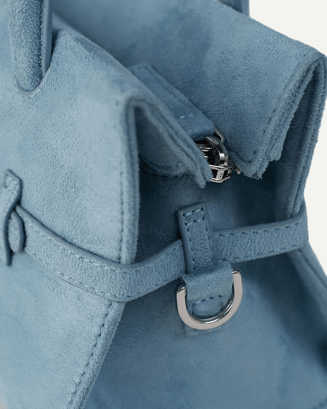Powder blue mini handbag close-up: buckle hardware and strap tab