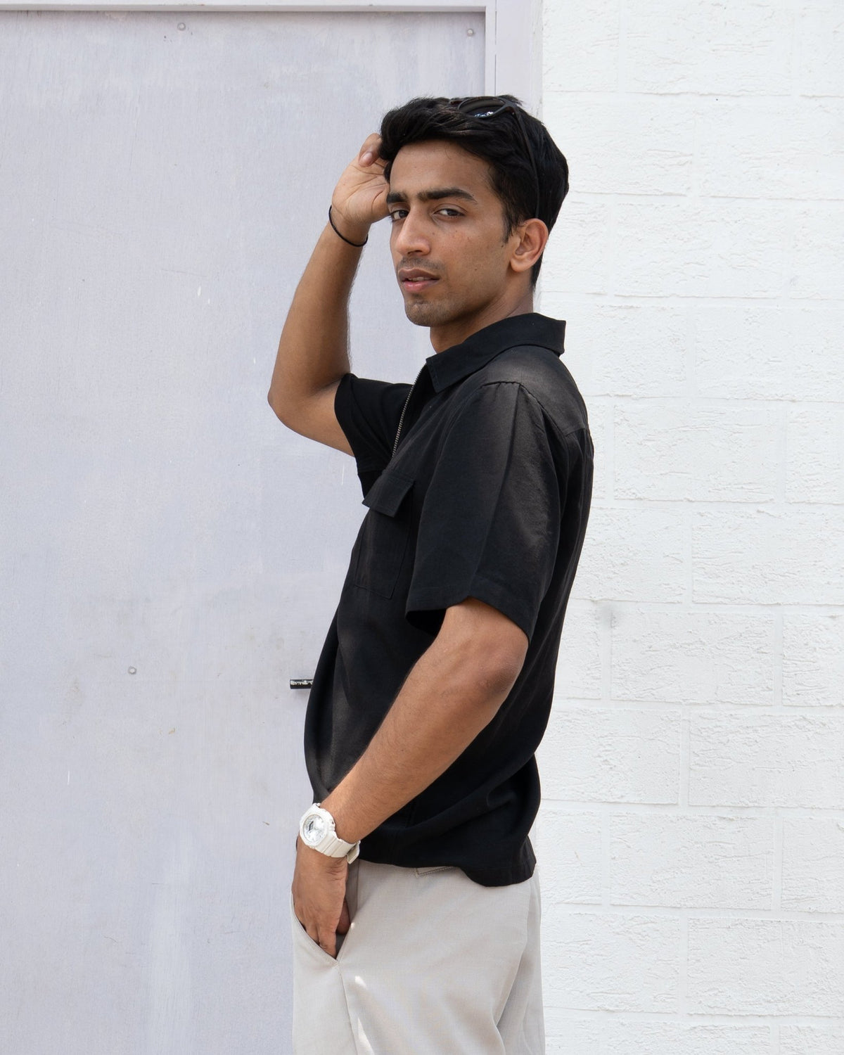 Men's black short-sleeve zip shirt, side profile with chest pocket