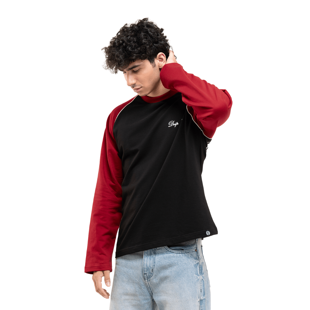 Men's black raglan baseball T-shirt with red sleeves and small white chest logo, side view