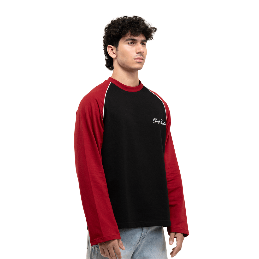 Men's black raglan T-shirt with red sleeves, crew neck, and small white chest logo