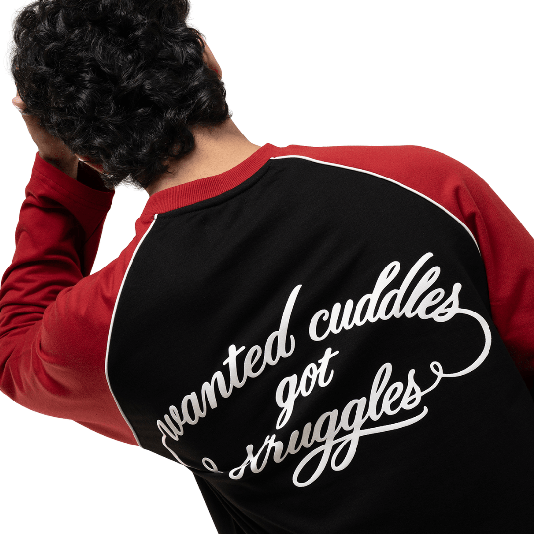 Men's black raglan T-shirt with red sleeves and large white script graphic on back