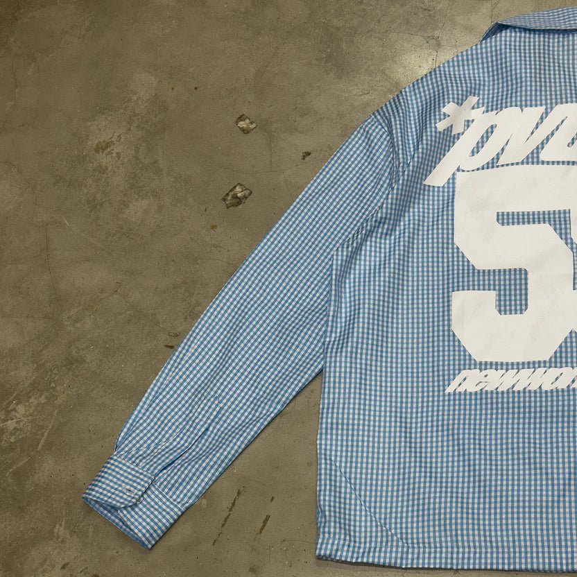 Blue check button-up shirt with white 25 graphic on back