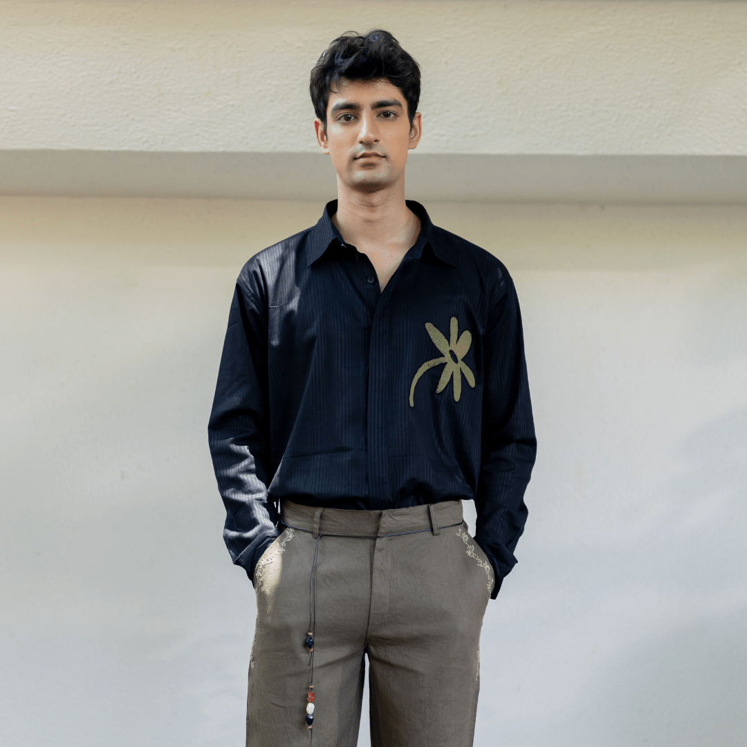 Olive embroidered trousers on model, with side stitching and bead drawstring