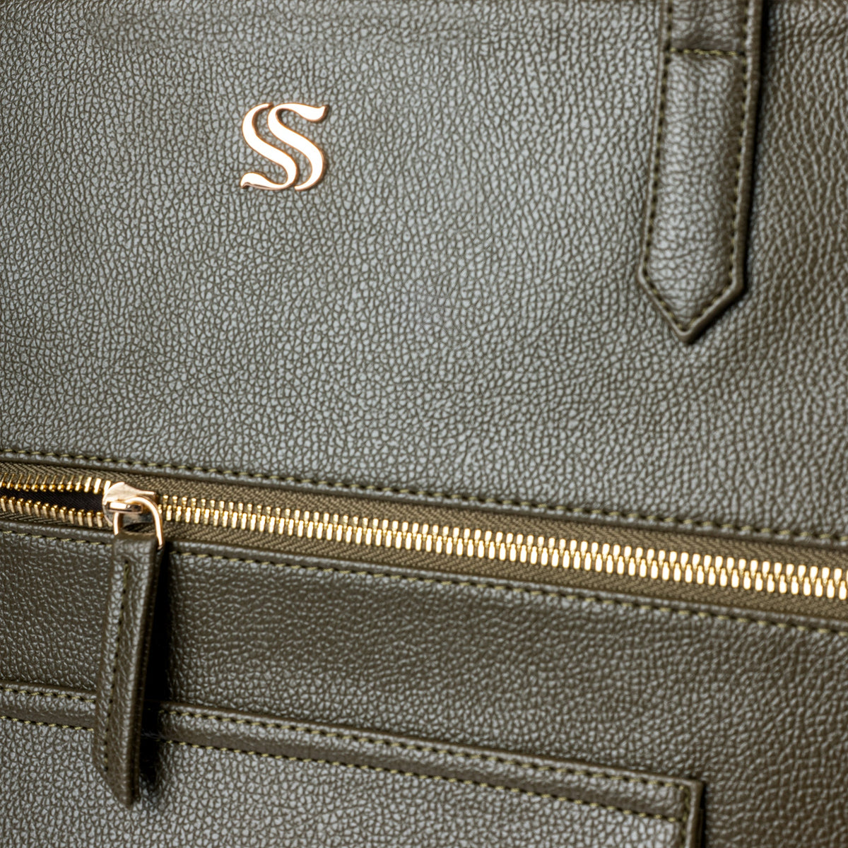 Olive tote bag front zipper pocket close-up with gold trim
