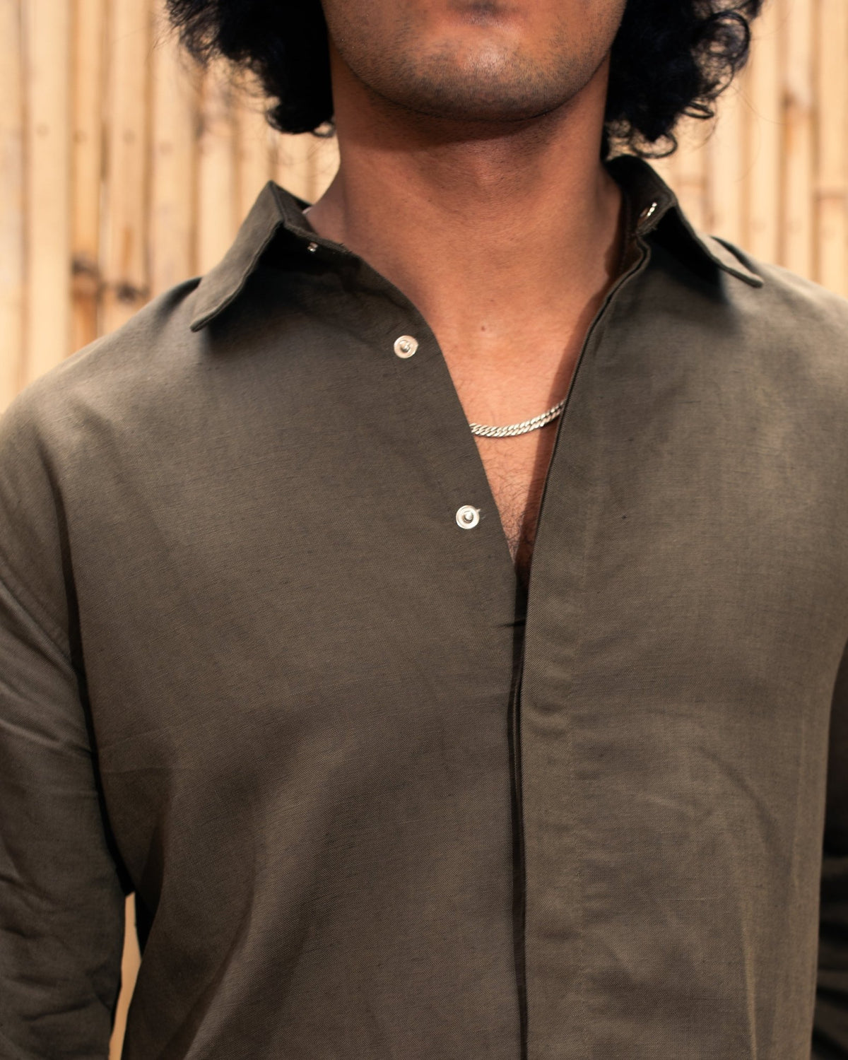 Olive snap-button shacket shirt close-up of stand collar and button placket