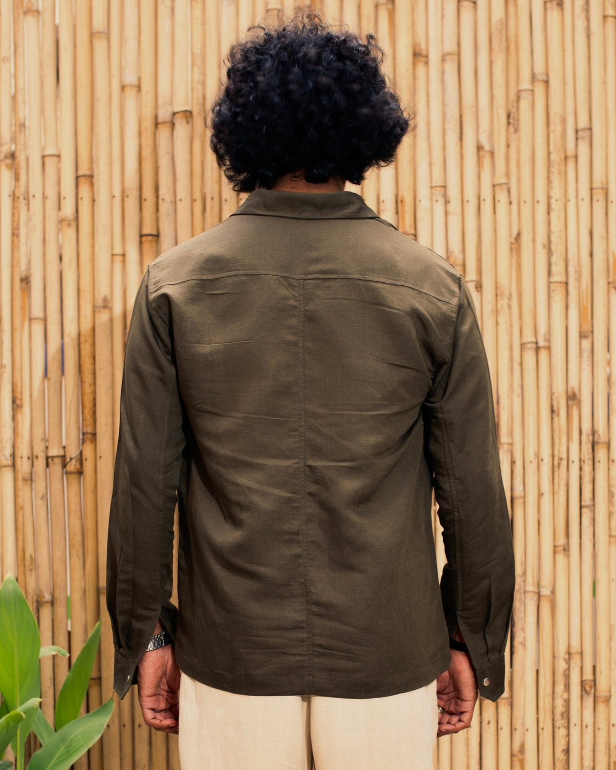 Olive snap-button shacket shirt with back yoke and long sleeves, rear view