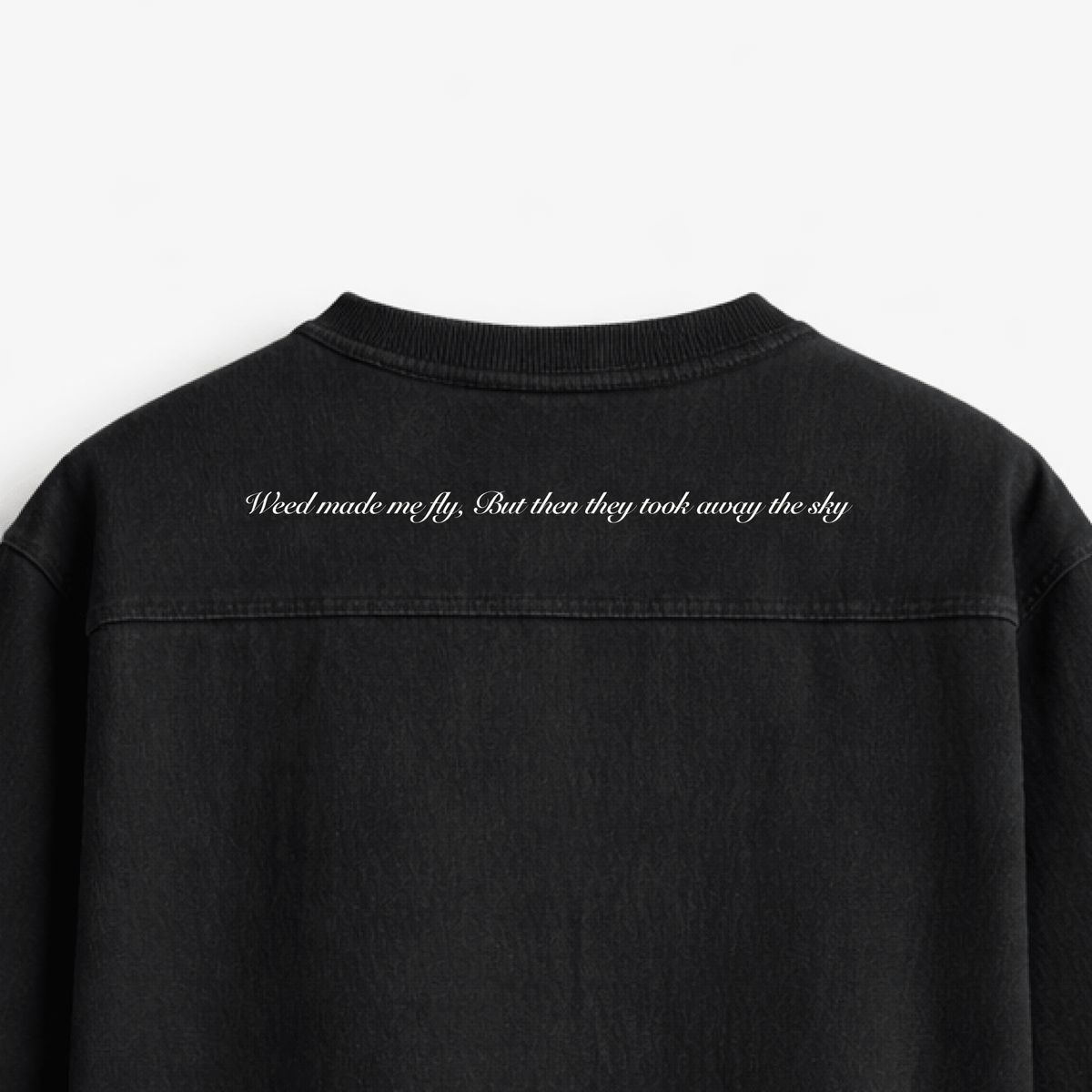 Black oversized boxy rugged T-shirt close-up of back quote text print