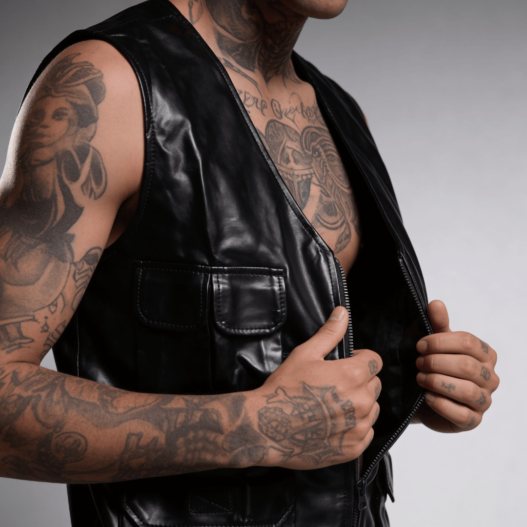 Black leather utility vest with front pockets and zipper closure with strap details