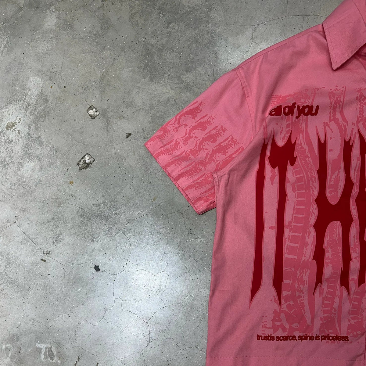 Pink short-sleeve button-up shirt with drips print on the front panel