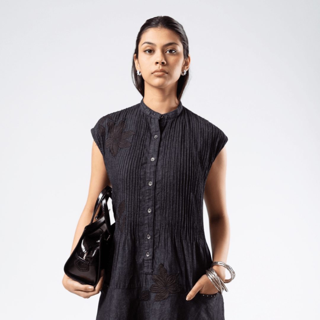 Pleated midi dress, sleeveless dark textured fabric with button front and round neckline.