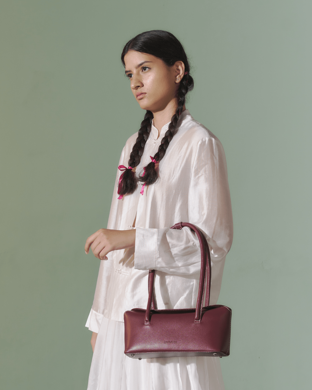 Burgundy leather-look top-handle bag with long handles and contrast stitching