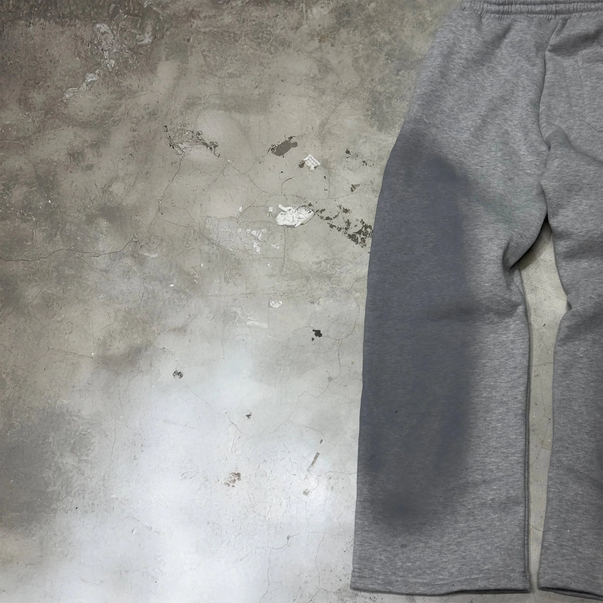 Grey track pants with elastic waistband and side pockets