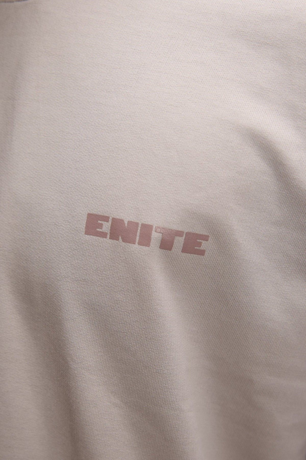 Light stone T-shirt close-up of 'ENITE' chest logo