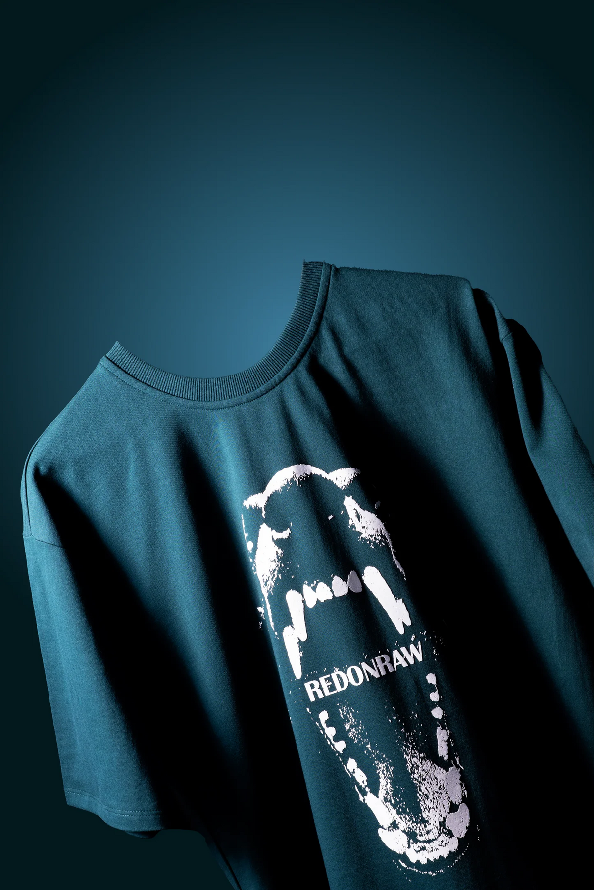Sea green T-shirt with large monster graphic and REDONRAW text on front