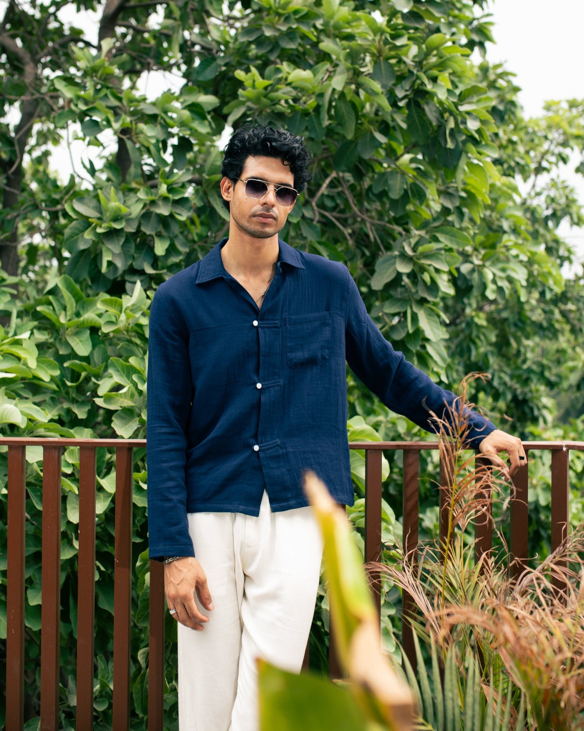 Navy long-sleeve button-up shirt with chest pocket and side slits
