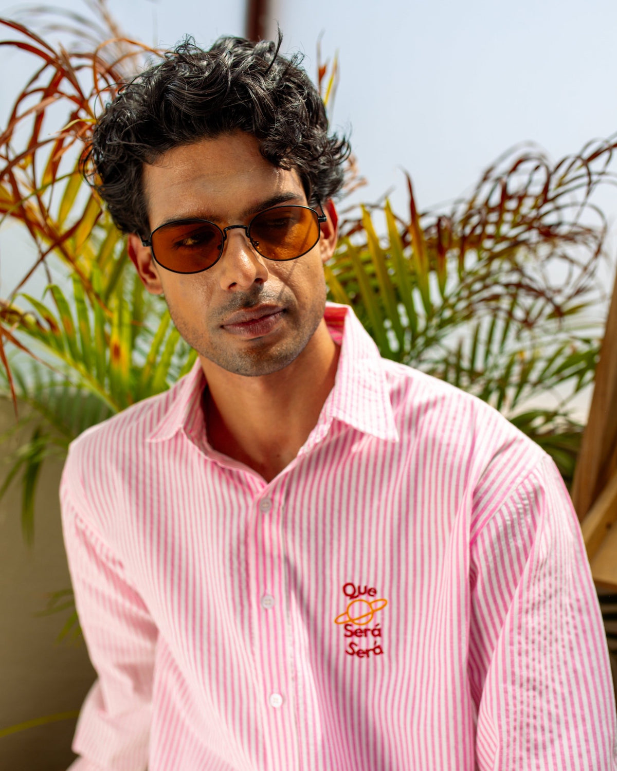Pink striped seersucker button-up shirt with embroidered logo and spread collar