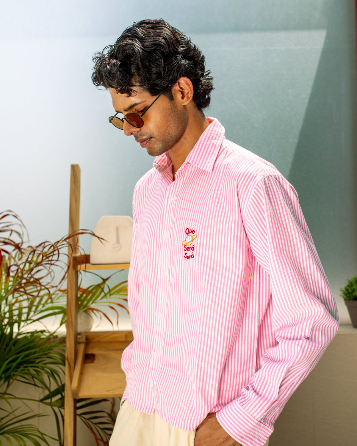 Pink striped seersucker button-up shirt with embroidered chest logo
